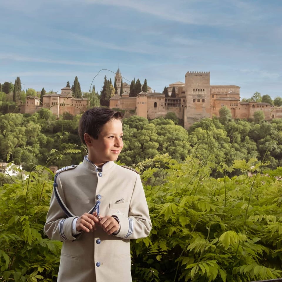 Niño de comunión con la Alhambra de fondo